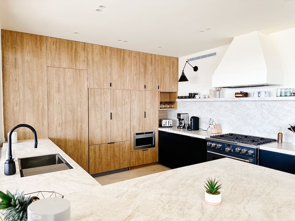Kitchen with wood cabinetry and a stone island